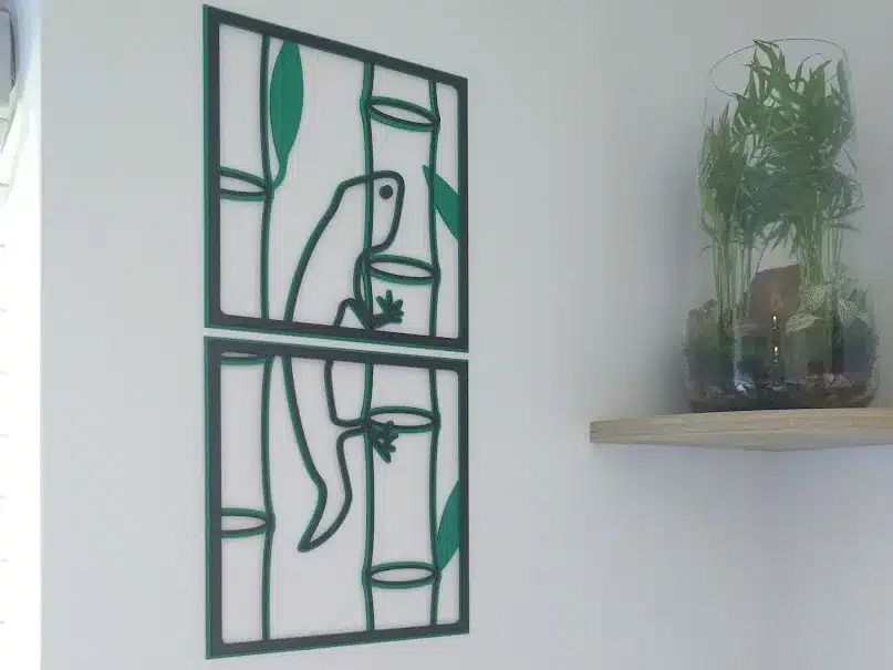 Wall art featuring a lizard and bamboo near a shelf with a glass terrarium, modern decor accent.