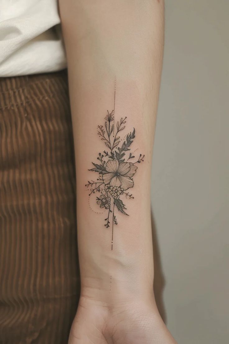 21 Stunning Black Feminine Floral Tattoo Designs Delicate floral tattoo with intricate design on forearm, featuring leaves and blossoms, minimalistic ink art. | Sky Rye Design Delicate floral tattoo with intricate design on forearm, featuring leaves and blossoms, minimalistic ink art.