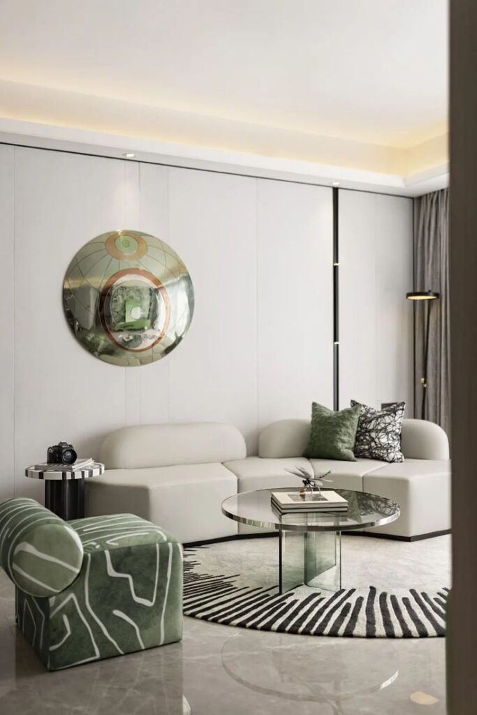 Modern living room with abstract decor, green accents, round glass table, and contemporary furniture design.