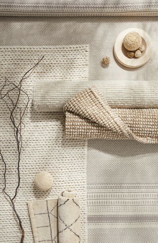 Neutral-toned woven textiles with natural decor elements, showcasing cozy home interior design accents.