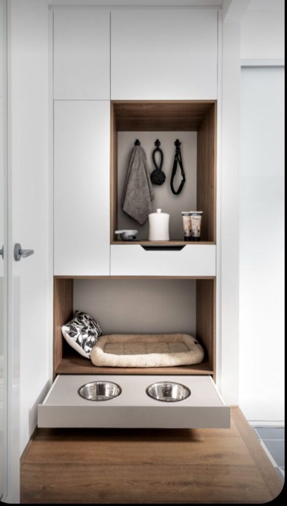 Modern pet station with cozy bed, feeding bowls, and organized storage perfect for dog care essentials in a sleek, stylish design.