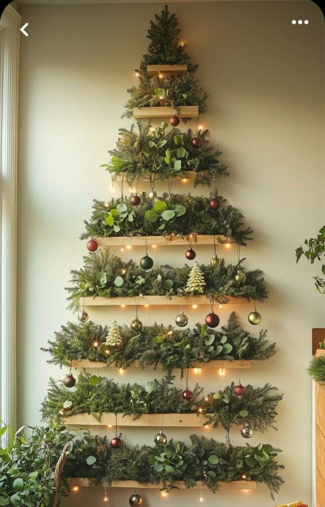Modern wall-mounted Christmas tree with lights and ornaments, made of wooden shelves and greenery. Festive and stylish decor.