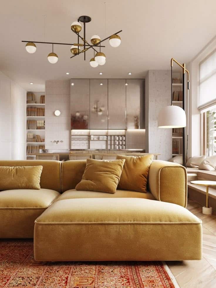 Stylish modern living room with mustard sofa, chic chandelier, and cozy ambiance.