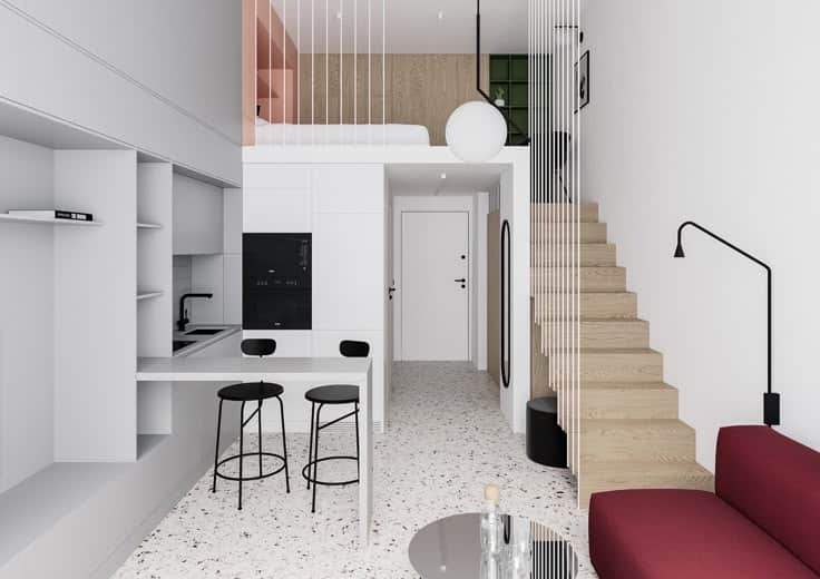 Modern loft apartment with open plan living area, cozy kitchen, and stylish staircase leading to a mezzanine bedroom.