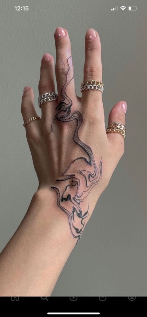 2c3270e2-1558-46dc-9d72-23c616585b4f Hand with abstract line tattoo and silver rings, showcasing artistic tattoo design and jewelry. | Sky Rye Design Hand with abstract line tattoo and silver rings, showcasing artistic tattoo design and jewelry.