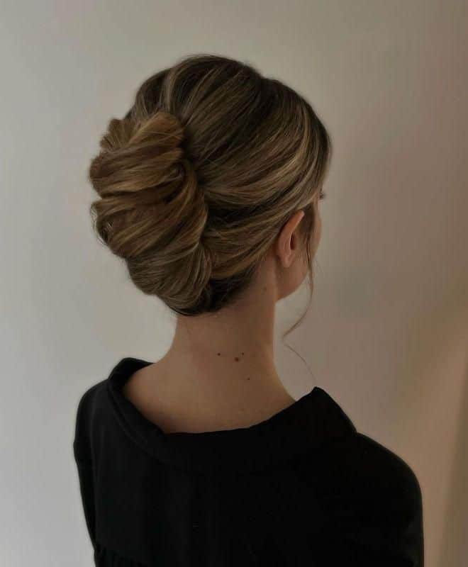 Elegant updo hairstyle with blonde highlights, perfect for formal occasions.