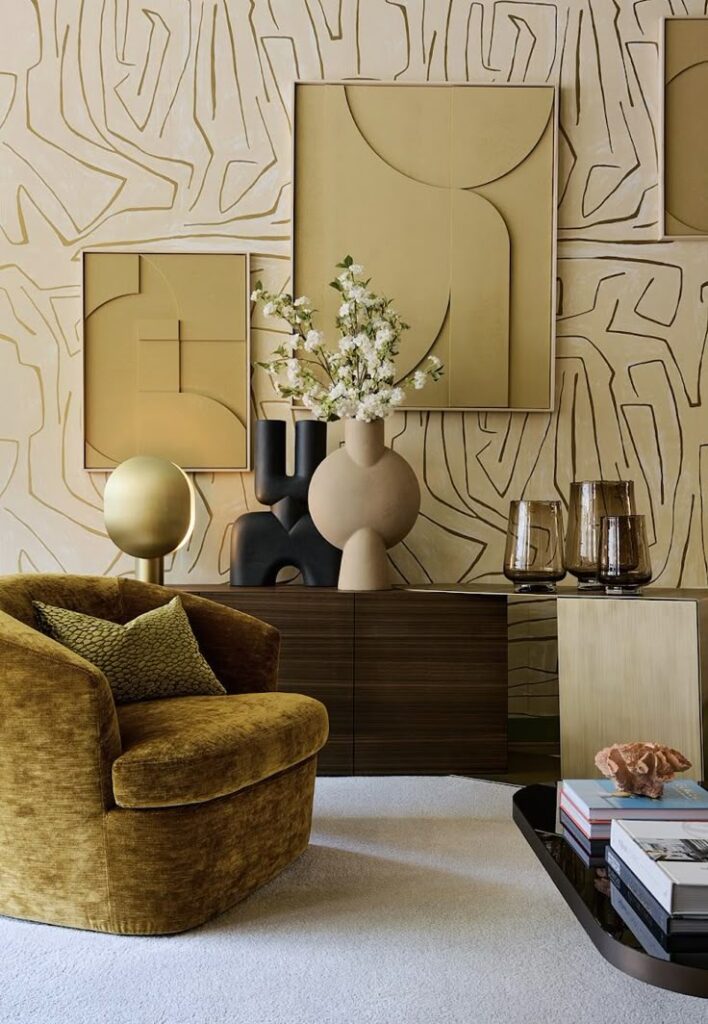 Stylish living room with mustard chair, abstract art, elegant vases, textured wallpaper, and modern decor.