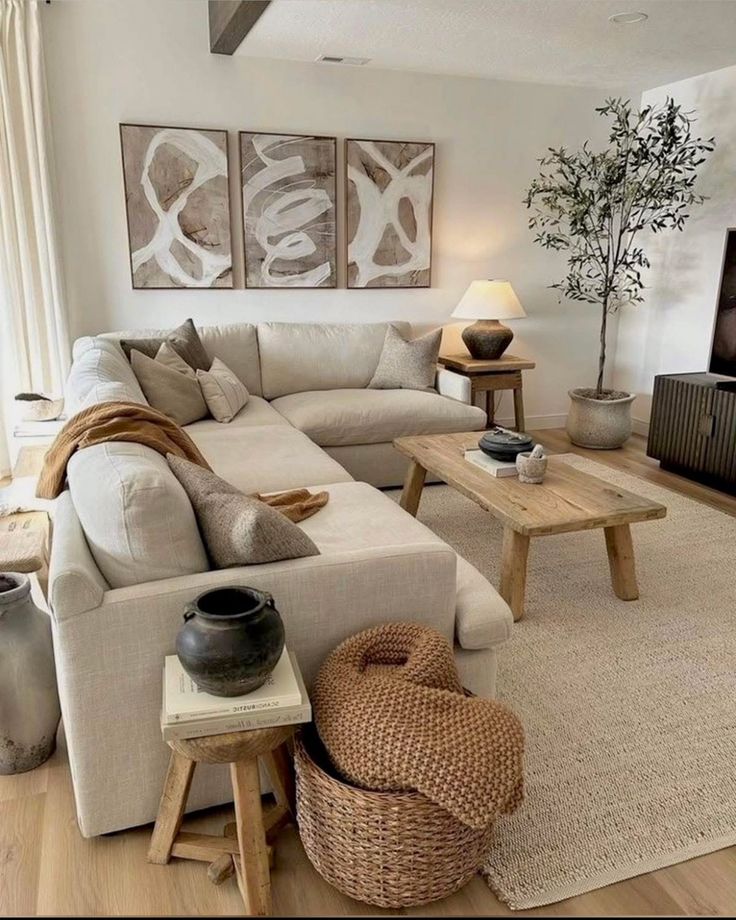 Stylish living room with neutral tones, cozy sectional sofa, textured decor, and abstract wall art.
