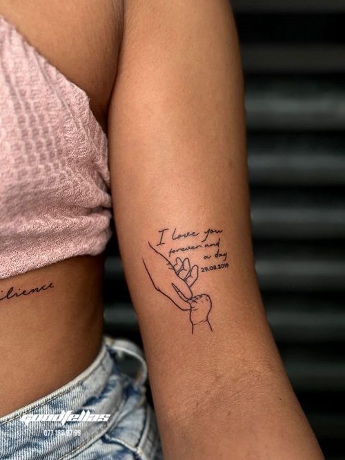 Minimalistic arm tattoo of two hands with handwritten text reading I love you forever and a day, 29.08.2019.