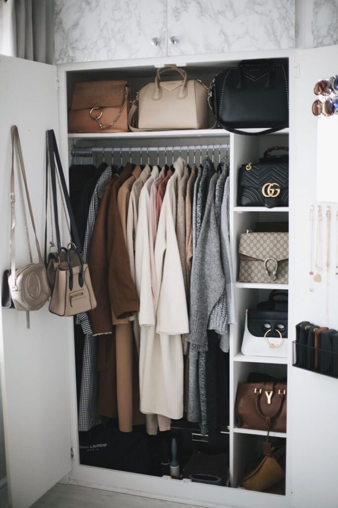 Stylish wardrobe with coats, handbags, and accessories neatly organized for chic and efficient storage.
