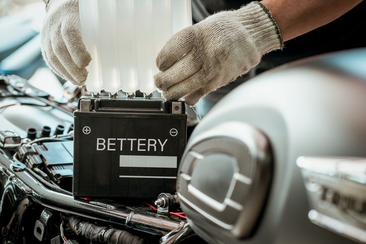 33 Things That Weigh Around 25 Kilograms Mechanic installing a battery on a motorcycle, hands in gloves adjusting the part. | Sky Rye Design Mechanic installing a battery on a motorcycle, hands in gloves adjusting the part.