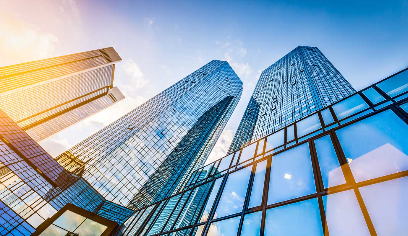334100-Real-estate-outlook-hero-1380x800px_ Skyscrapers reflecting sunlight with a blue sky backdrop, emphasizing modern architecture and urban landscape. | Sky Rye Design Skyscrapers reflecting sunlight with a blue sky backdrop, emphasizing modern architecture and urban landscape.