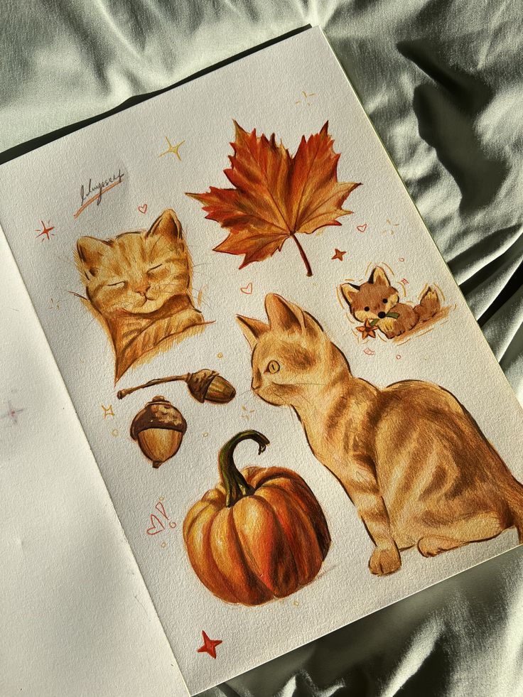 Illustrated autumn-themed art with a cat, pumpkin, maple leaf, and acorns on a sketchbook page.