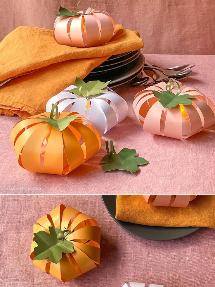 Frosted paper pumpkin lanterns on a table with orange napkins and plates, perfect for autumn decor.