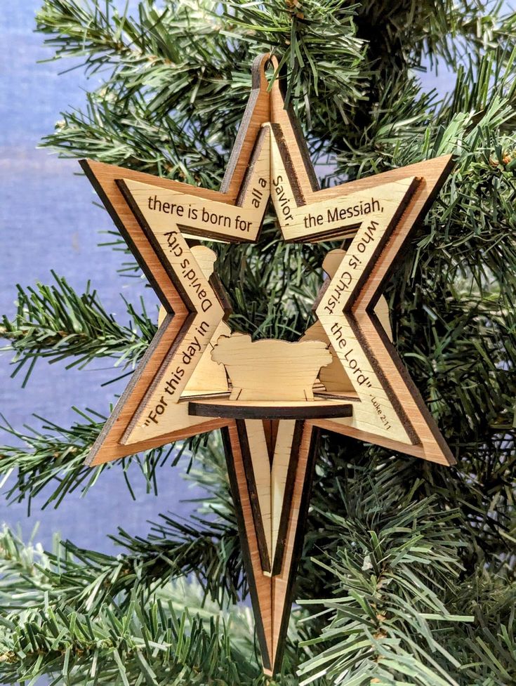 3D Bethlehem Star Nativity Ornament with Scripture Wooden star ornament with Bible verse decorates Christmas tree branch. | Sky Rye Design Wooden star ornament with Bible verse decorates Christmas tree branch.