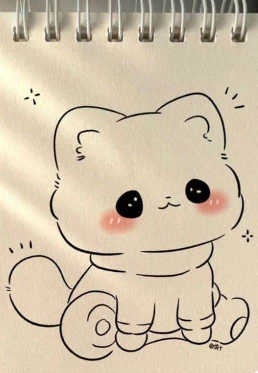 Cute cat drawing with round eyes and blushing cheeks on spiral-bound paper. Perfect for kawaii illustration fans.