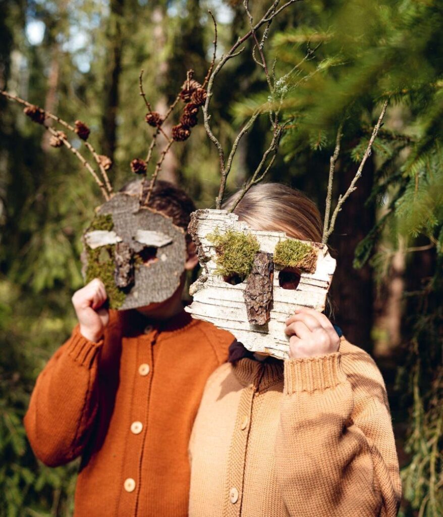 3ca91db8cb7573b76e53542ebe1338f2 Children wearing nature-inspired wooden masks with branches in a forest setting. | Sky Rye Design Children wearing nature-inspired wooden masks with branches in a forest setting.