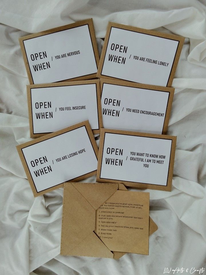 Open When letters for various emotions on a bed, offering comfort and encouragement in times of need.
