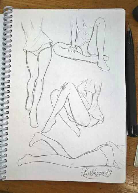 Sketchbook drawing of various seated figure poses, focusing on legs and casual posture, alongside a pen.