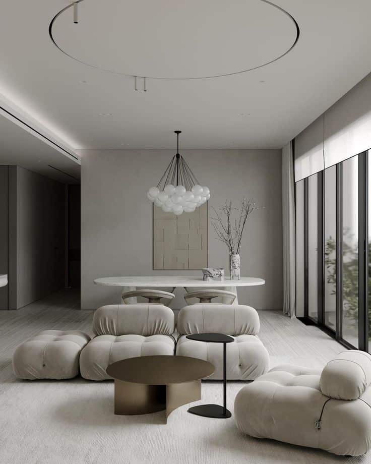 Modern living room with minimalist decor, plush seating, round tables, and large windows for natural light.