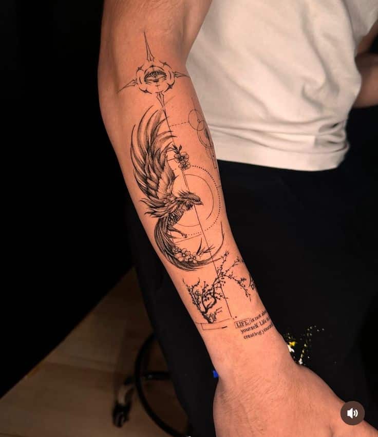 Forearm tattoo featuring detailed phoenix design with geometric elements and intricate linework.