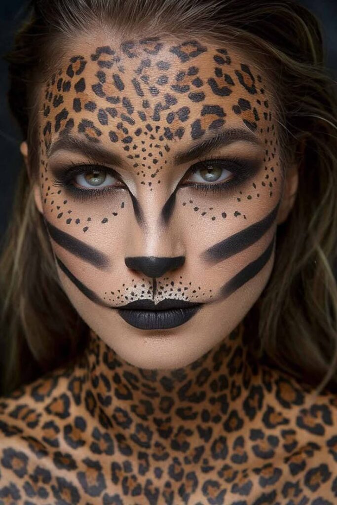 Woman with leopard face paint and spotted body art, showcasing creative makeup skills and animal-inspired design.