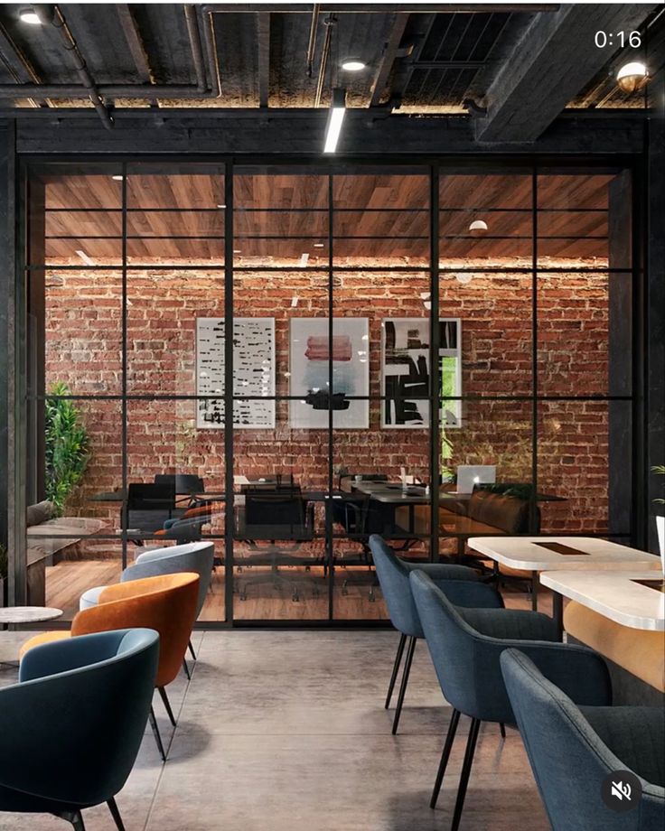56402a10-eb10-43f2-b1c5-c3931819ece0 Modern office with exposed brick, glass walls, and stylish seating. Cozy workspace ambiance. | Sky Rye Design Modern office with exposed brick, glass walls, and stylish seating. Cozy workspace ambiance.