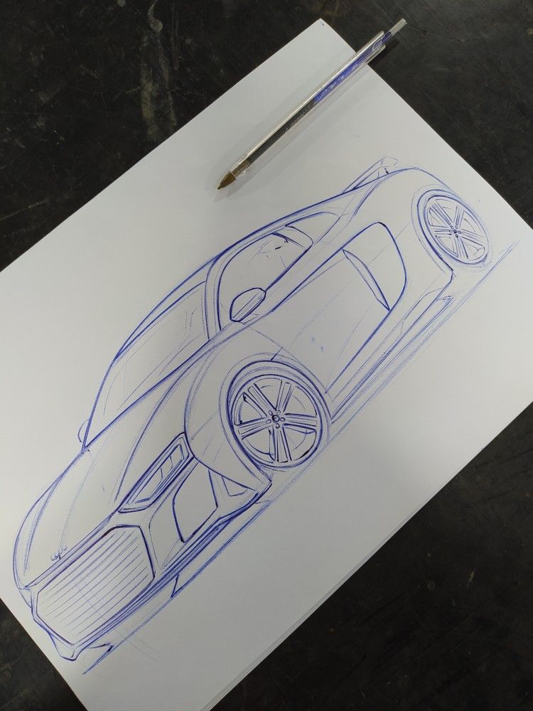 Car design sketch on paper with pen, showcasing sleek lines and modern aesthetics.
