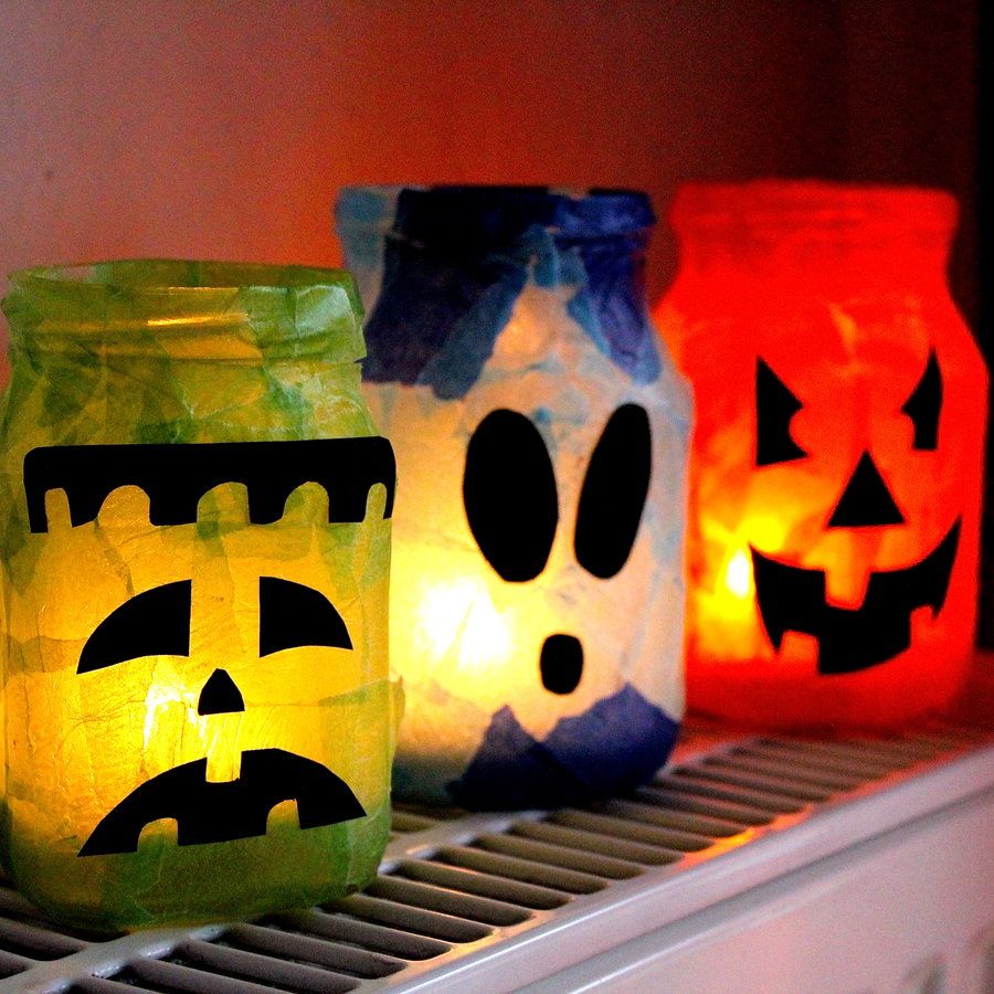 59eed0d500da6d200e55eb003497a063 Festive Halloween lanterns made from jars with spooky faces in green, blue, and orange glowing lights. | Sky Rye Design Festive Halloween lanterns made from jars with spooky faces in green, blue, and orange glowing lights.