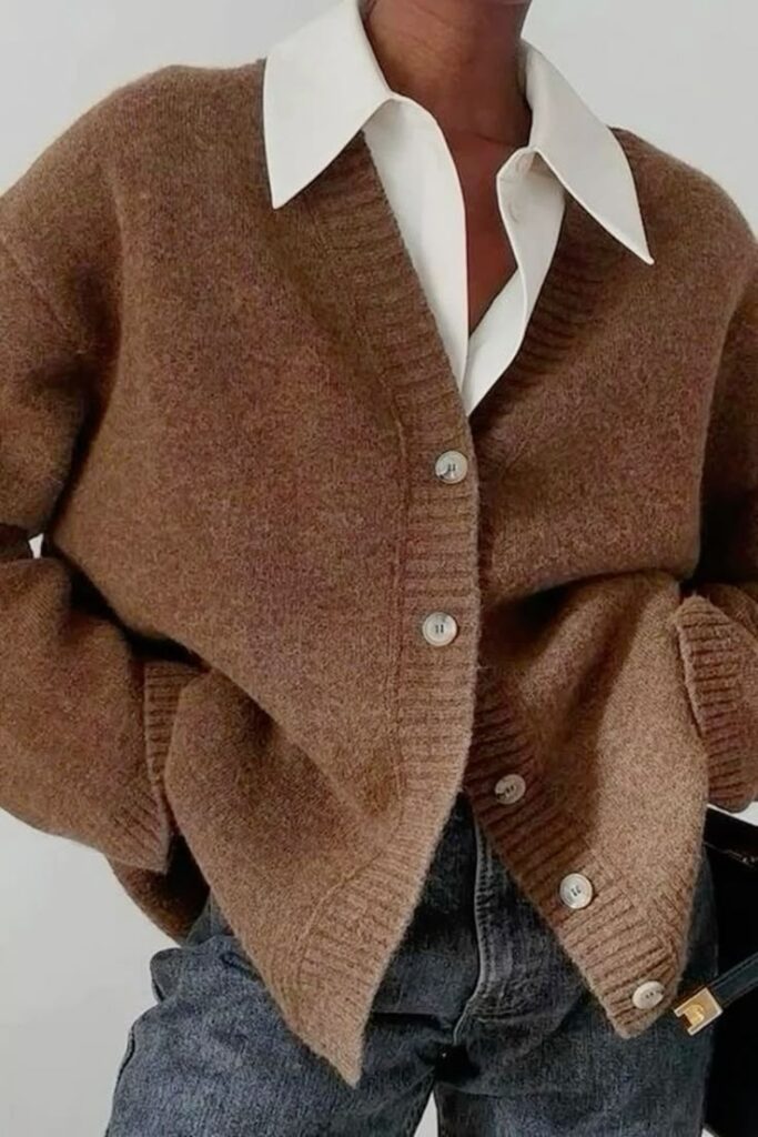 Stylish brown cardigan over a white shirt paired with denim jeans for a cozy, chic look.