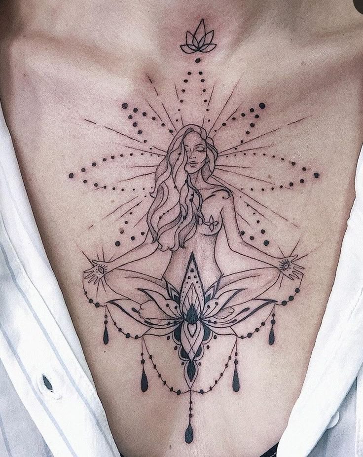 Elegant tattoo of a meditating woman with floral and geometric designs on chest, symbolizing peace and spirituality.