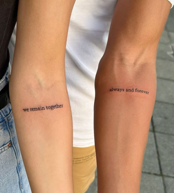 Forearm tattoos reading we remain together and always and forever on two people standing side by side.