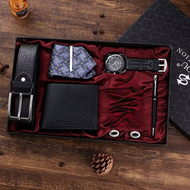 Men's gift set with belt, wallet, watch, tie, pen, and cufflinks on a wooden table, perfect for special occasions.
