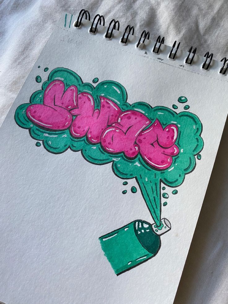 Graffiti art sketch on notepad with pink letters and green spray paint can, creative urban street style design.