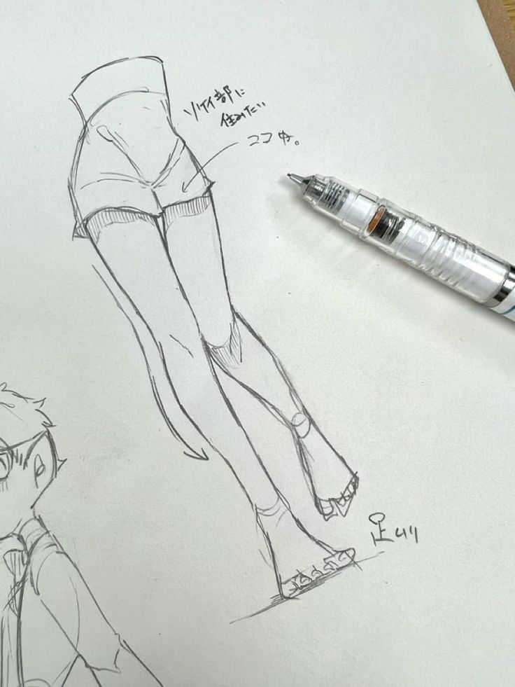 Pencil sketch of a character's legs and shorts with Japanese annotations, next to a mechanical pencil.