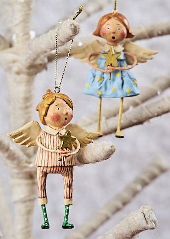 _ 7 Two whimsical angel ornaments holding stars, hanging on a frosted tree, perfect for festive Christmas decoration. | Sky Rye Design Two whimsical angel ornaments holding stars, hanging on a frosted tree, perfect for festive Christmas decoration.