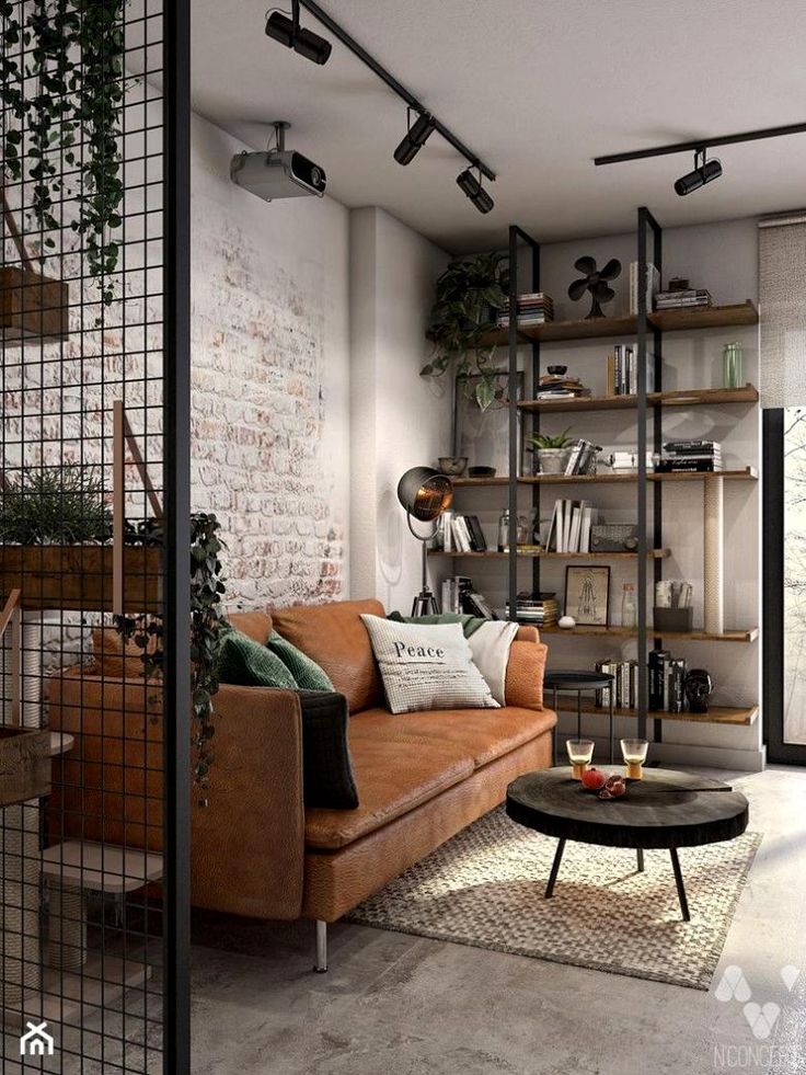 Cozy living room with brown leather sofa, rustic decor, and industrial shelving. Modern and stylish interior design.