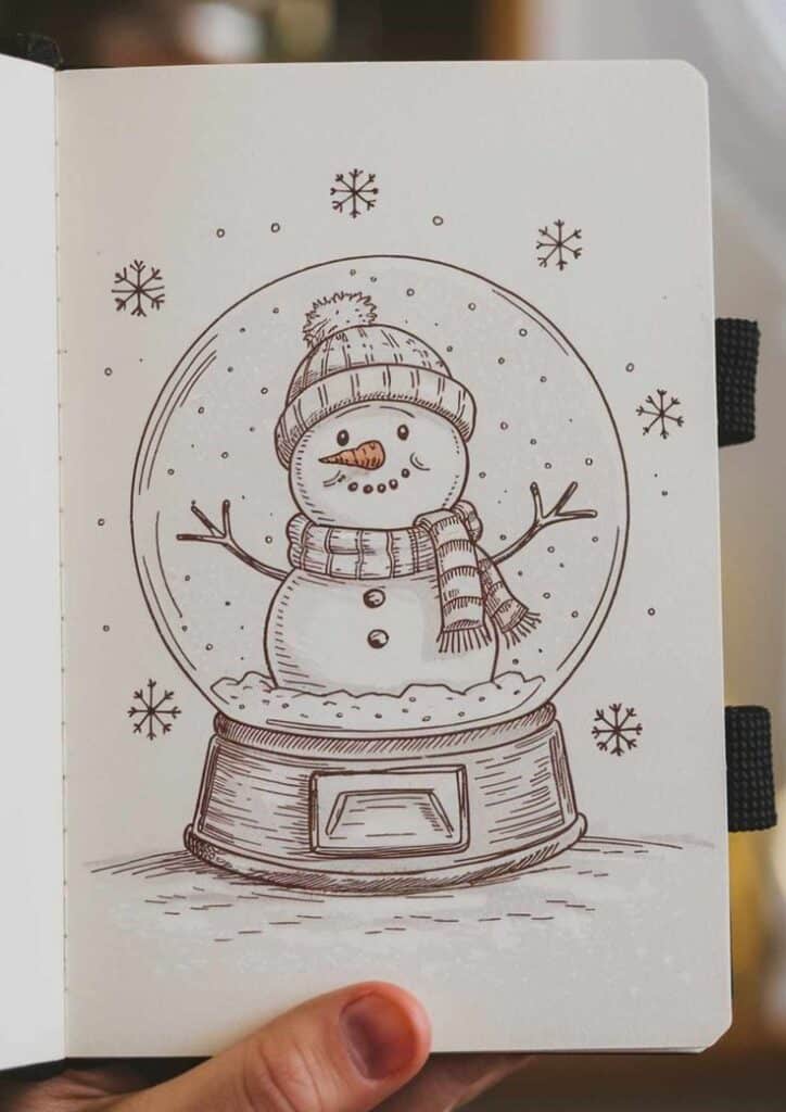 70+ Winter Drawing Ideas Cozy Simple Winter Drawings to Try - Artsydee - Drawing Painting _ Illustrated snowman in a glass snow globe, wearing a hat and scarf, surrounded by falling snowflakes. | Sky Rye Design Illustrated snowman in a glass snow globe, wearing a hat and scarf, surrounded by falling snowflakes.