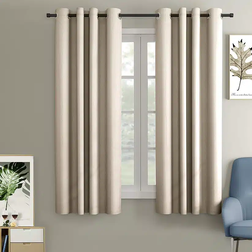 Modern living room with beige curtains, a window, and minimalist decor accents.