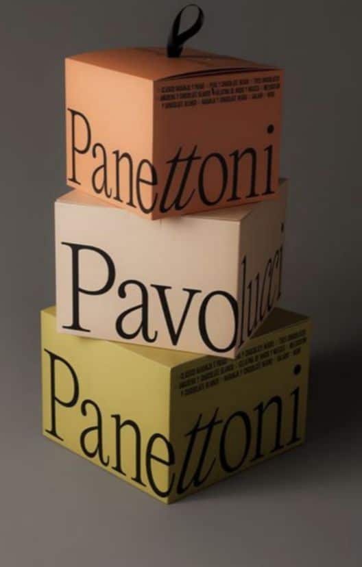 Stacked Panettoni Pavolucci boxes in pastel colors, showcasing elegant Italian packaging design.