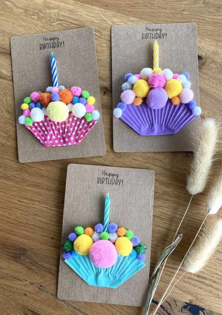 78f2843510bfd3a6be553296daff7121 Colorful DIY birthday cards with pom-pom cupcakes and candles on a wooden table. | Sky Rye Design Colorful DIY birthday cards with pom-pom cupcakes and candles on a wooden table.
