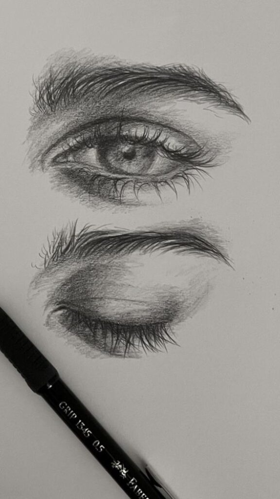 7947bc88-8941-46d4-b760-3af3df145f7b Pencil sketch of open and closed eyes with fine detail, showcasing shading techniques. Black Faber-Castell pen nearby. | Sky Rye Design Pencil sketch of open and closed eyes with fine detail, showcasing shading techniques. Black Faber-Castell pen nearby.