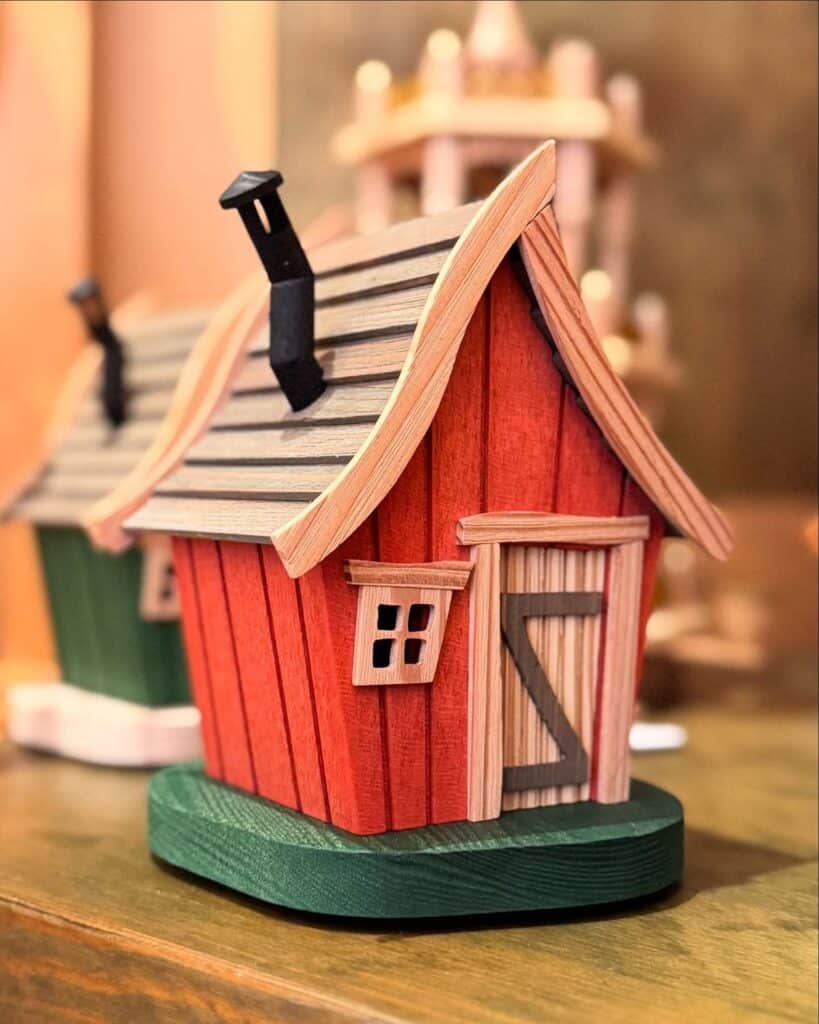 82b47e38fbf324ab7f17566f8348accf Colorful wooden birdhouse with red walls and black chimney on a green base, perfect for rustic decor. | Sky Rye Design Colorful wooden birdhouse with red walls and black chimney on a green base, perfect for rustic decor.