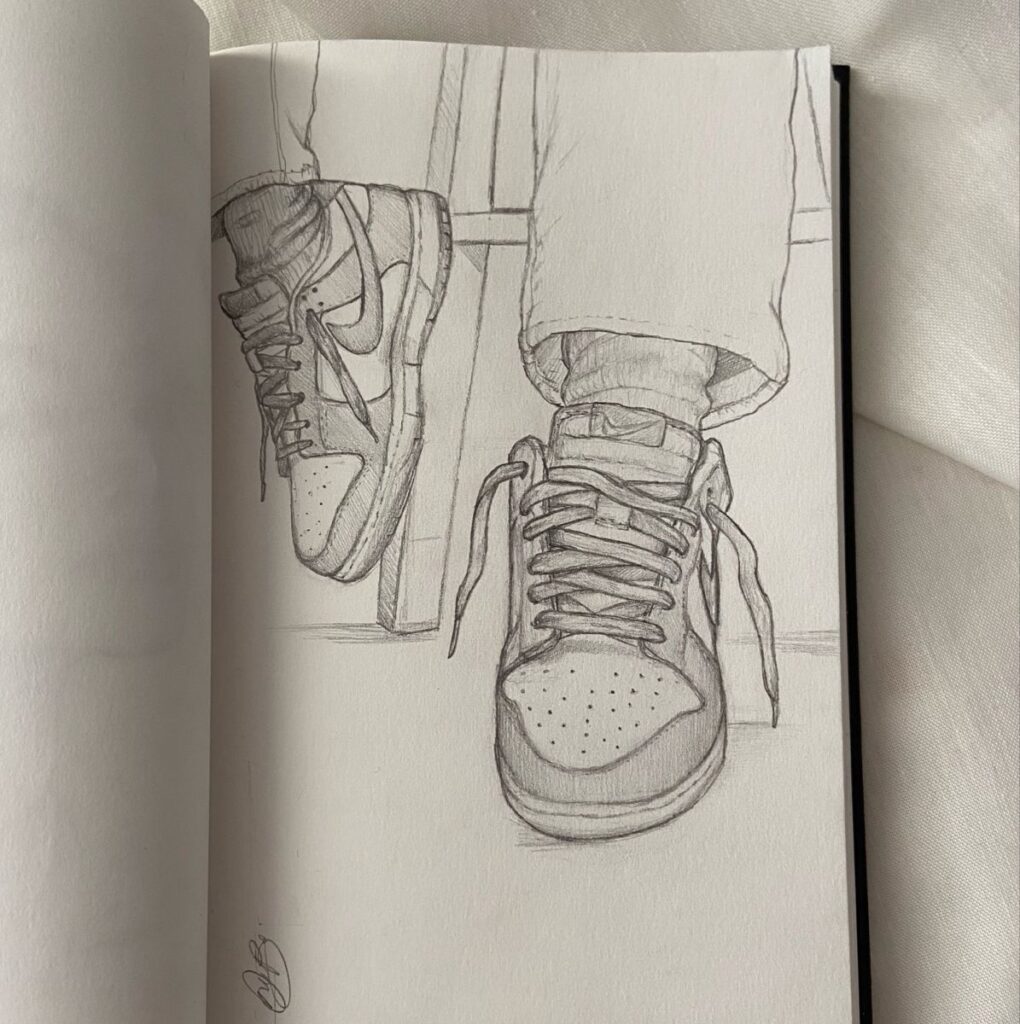 Pencil sketch of a person wearing stylish sneakers, legs crossed, showcasing detailed shoe design and casual outfit.