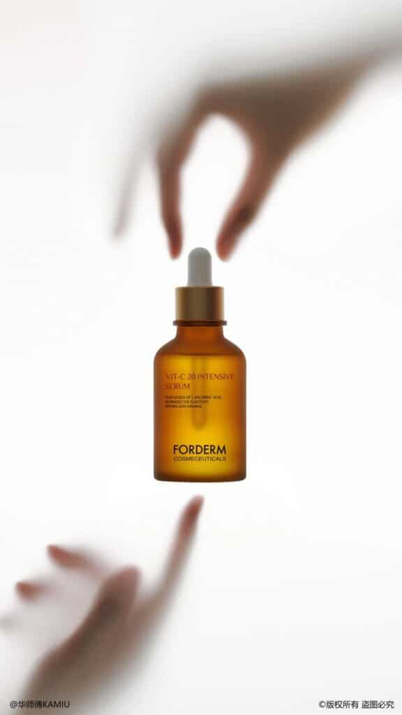 Vit-C 20 Intensive Serum by Forderm, bottle with dropper, blurred hands in background, skincare product image.