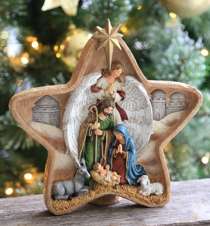 _ 9 Star-shaped nativity scene with angel, Mary, Joseph, and baby Jesus before a Christmas tree background. | Sky Rye Design Star-shaped nativity scene with angel, Mary, Joseph, and baby Jesus before a Christmas tree background.