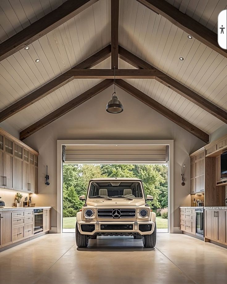 Luxury SUV parked in a spacious, modern garage with wooden cabinets and open door to greenery.