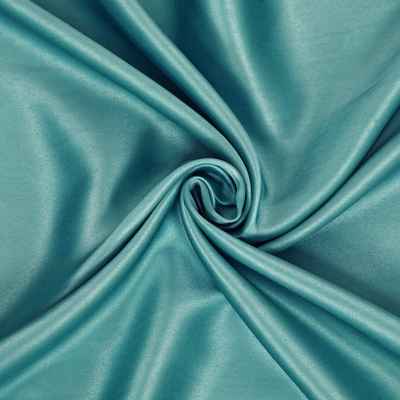 Close-up of teal satin fabric with elegant draping and swirl pattern, showcasing smooth texture and glossy finish.
