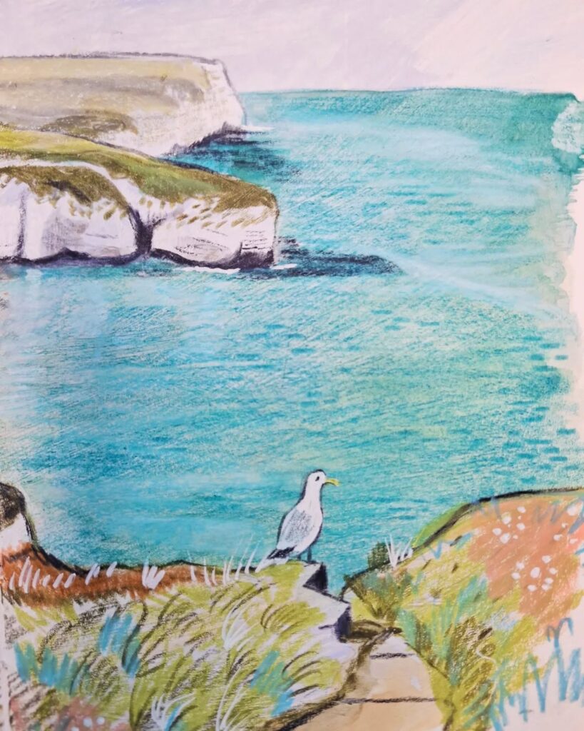 Seagull on a coastal cliff with blue ocean waves in the background, illustrating a serene coastal landscape.
