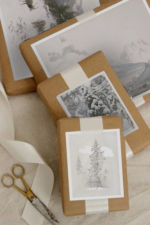 Brown paper packages with white ribbon and nature-themed artwork, surrounded by scissors and ribbon, on a beige surface.